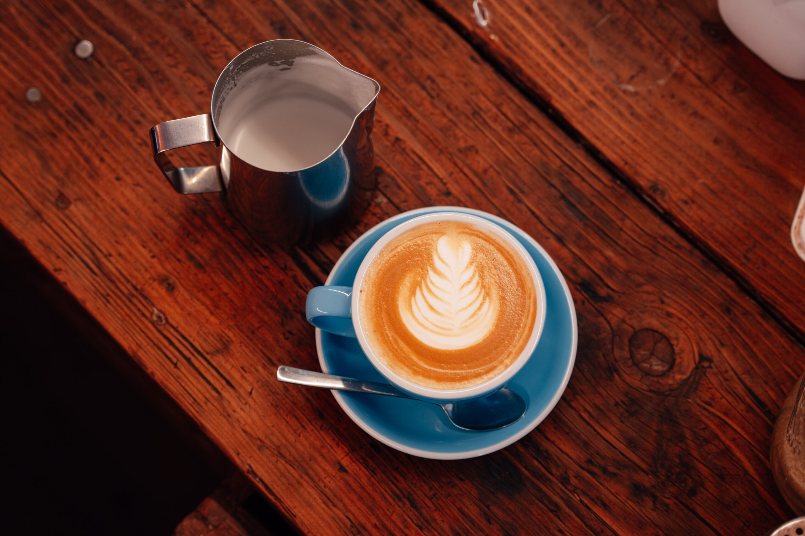 Flat white on a wooden table in the Speedshop cafe