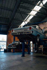 Classic car on the hoist in the Speedshop workshop