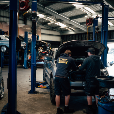 Mechanic servicing a car in the Speedshop workshop